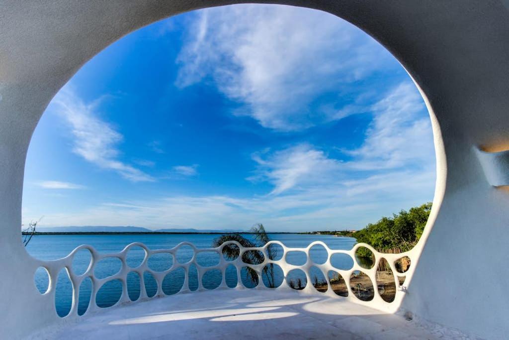a view of the ocean through an archway at Shark Studio Retreat at Swan Villas - Gold Standard Certified in Maya Beach