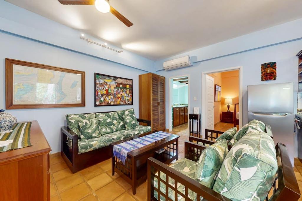a living room with a couch and a table at Condo #24 @ Beachside Villas in Placencia