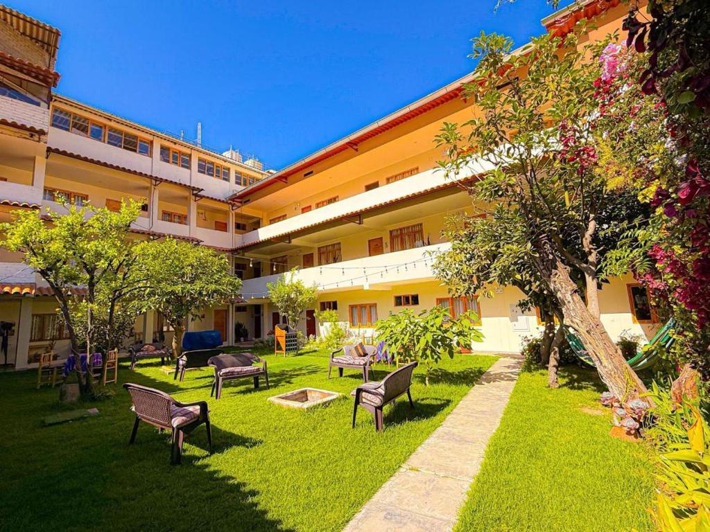 a courtyard of a building with chairs and trees at Alpamayo Casa Hotel - Restaurante in Yungay