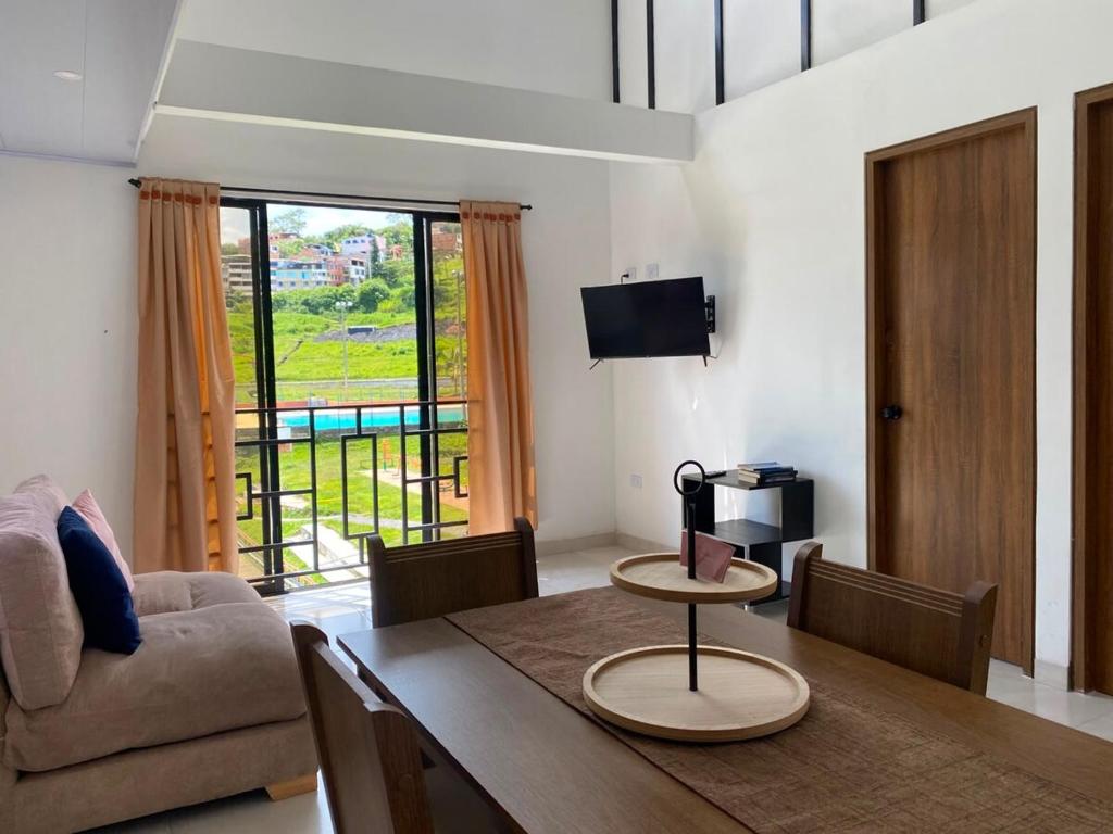a living room with a table and a couch at apartamento dúplex con balcón y central in Estación El Salto