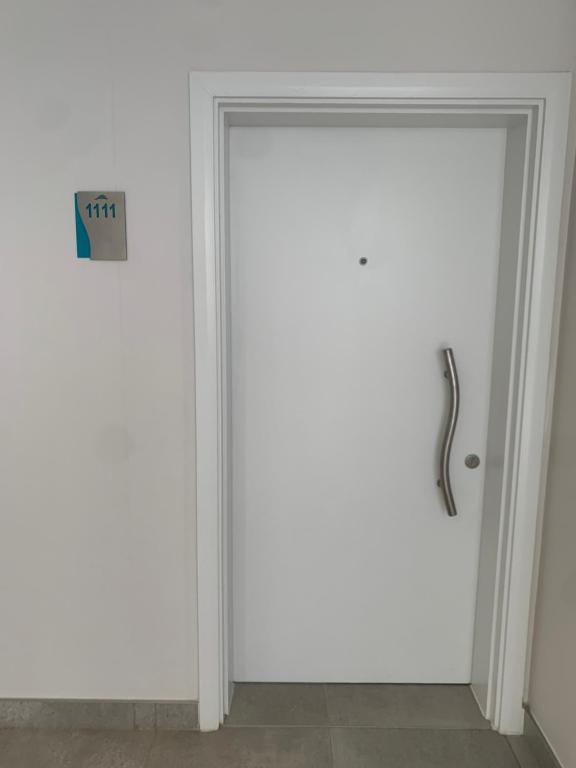 a door with a handle in a room at Oceans Apartment in Durban