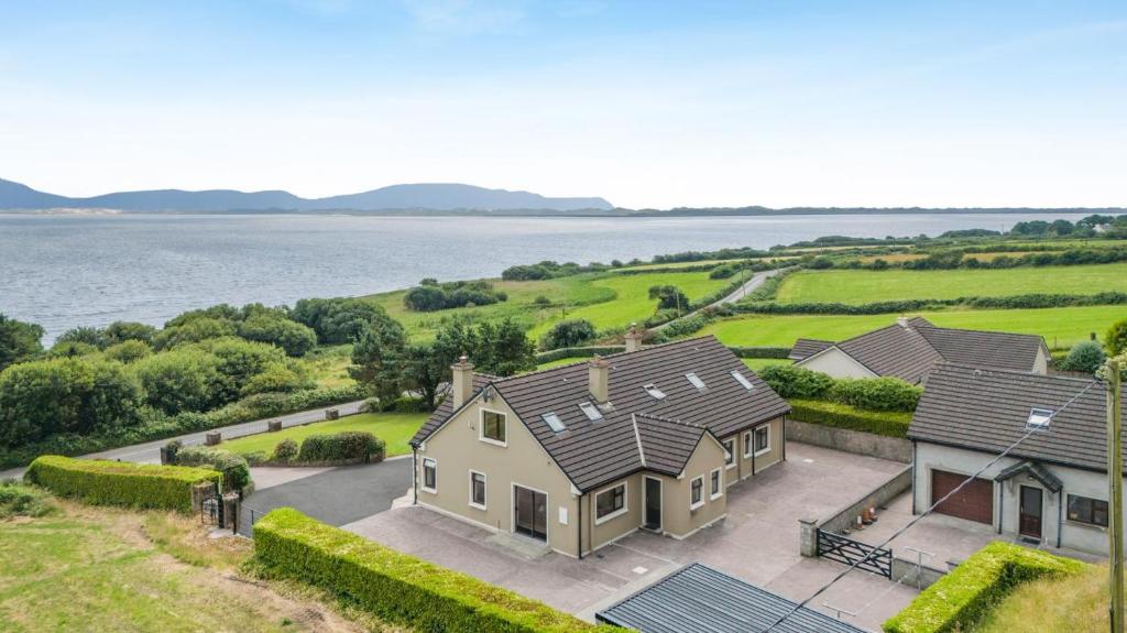 an aerial view of a house with a view of the water at 4 Bed in Inch oc-ii11636 in Caheracruttera