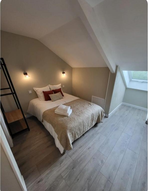 a bedroom with a large bed in a attic at Studio Havane avec clim in Bourbonne-les-Bains