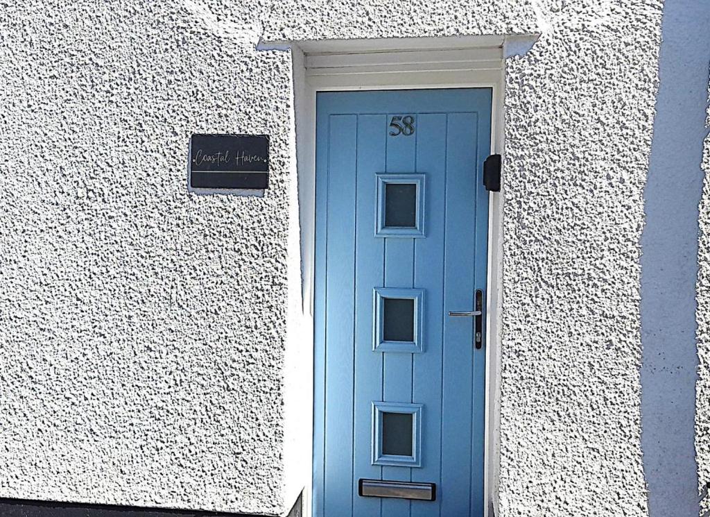 a blue door on the side of a building at 3 Bed in Dawlish oc-c29669 in Dawlish