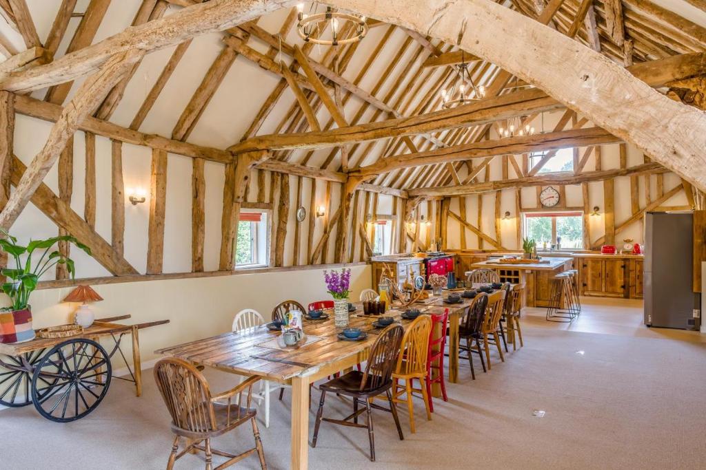 a large dining room with wooden tables and chairs at 6 Bed in Ardleigh oc-b35089 in Ardleigh