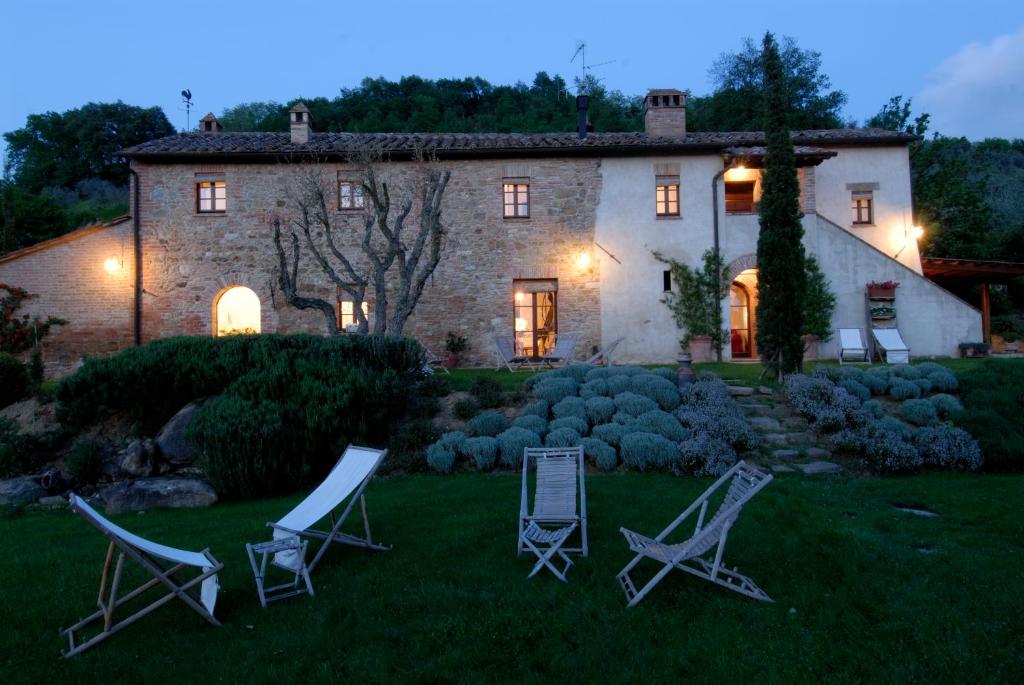 a group of lawn chairs in front of a house at Podere Poggio al sole in Montepulciano
