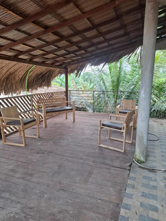 a group of benches sitting under a roof at Casa de Praia in Belém