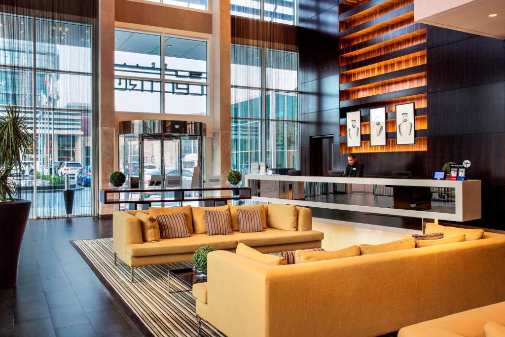 a lobby with couches and tables in a building at Centro Yas Island-by Rotana in Abu Dhabi