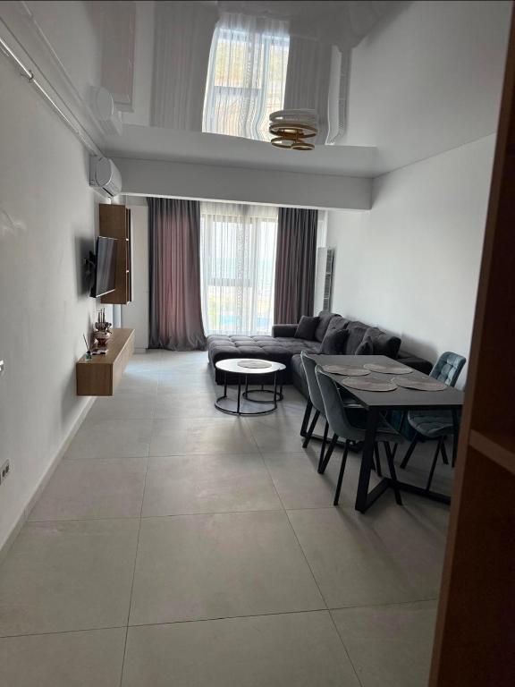 a living room with a couch and a table at Ștefan Seafront Residence in Năvodari