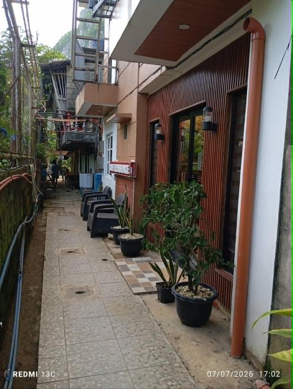 a row of potted plants sitting next to a building at Raje Residence El Nido in El Nido