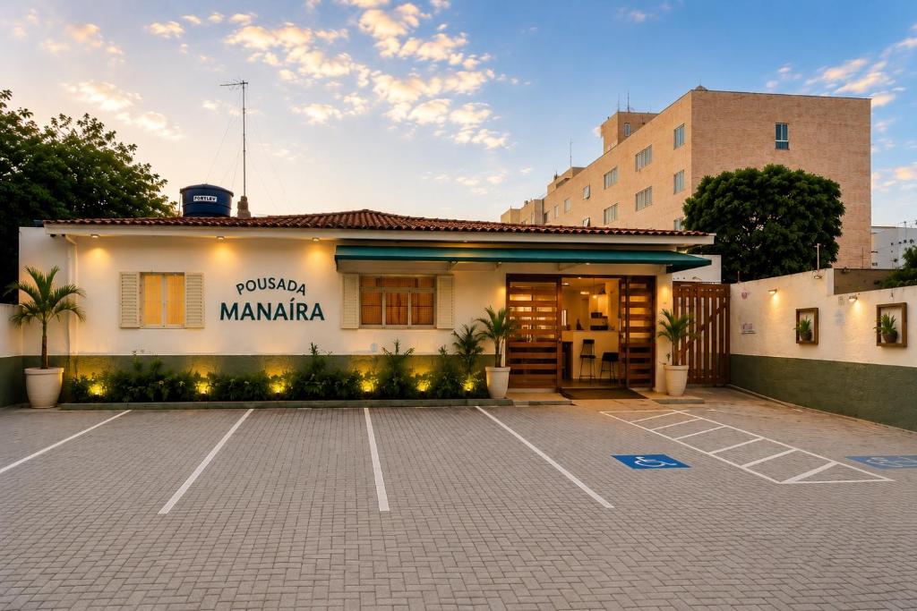 a parking lot in front of a building at Pousada Manaíra in João Pessoa