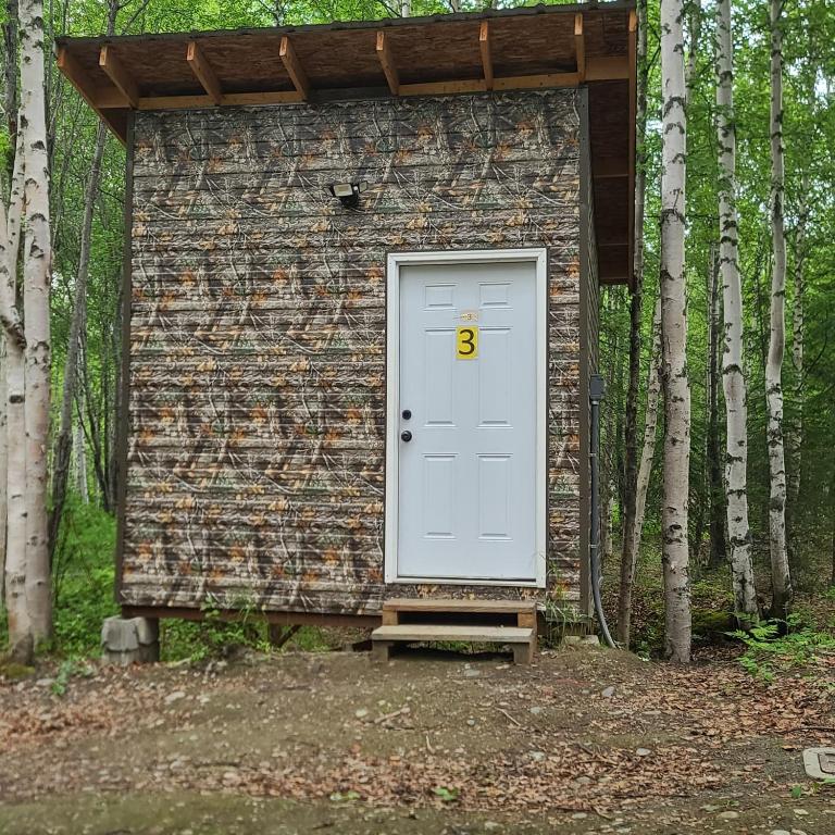 a white door with the number six in front of a building at Bears Den Cabin #3 in Houston