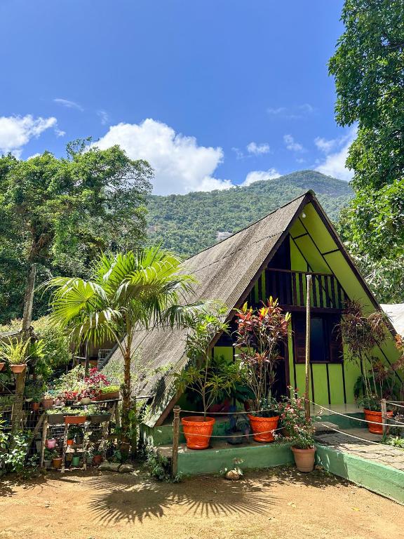 a small house with plants in front of it at Chale do Índio - Ilha Grande in Angra dos Reis