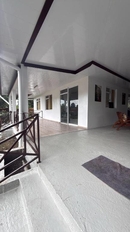 a large empty building with a large room with windows at Tevaatua house in Papara