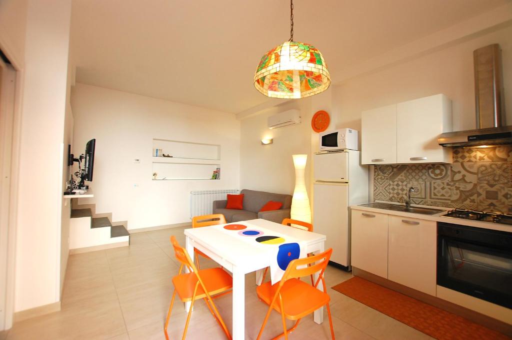 a kitchen with a white table and chairs in a room at Casa Vacanza "Donna Franca" in Castellammare del Golfo