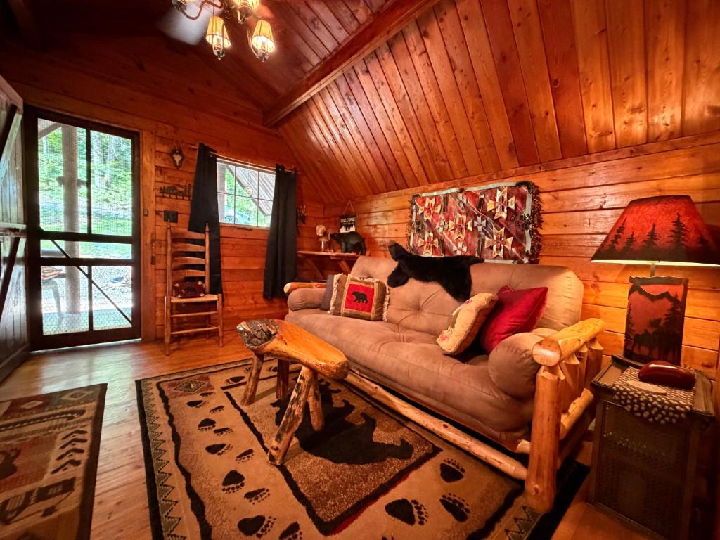 a living room with a couch in a log cabin at Big Bear Log cabin in Cosby
