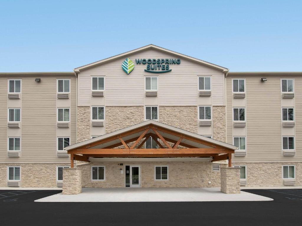 a large building with a sign on top of it at WoodSpring Suites in Glendale