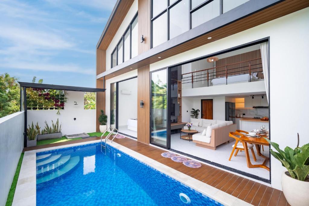 an image of a house with a swimming pool at Villa Effata close to Black Sand Beach in Keramas