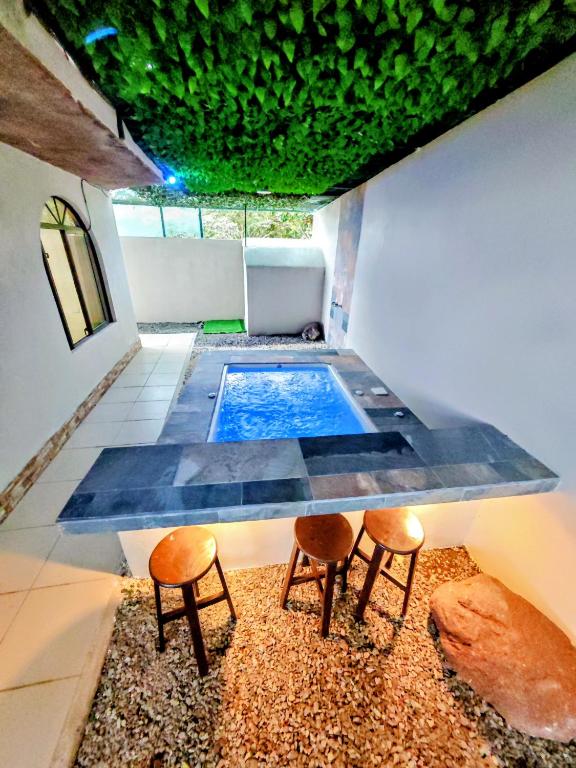 a swimming pool with two chairs and a table at Alinas House in Fortuna
