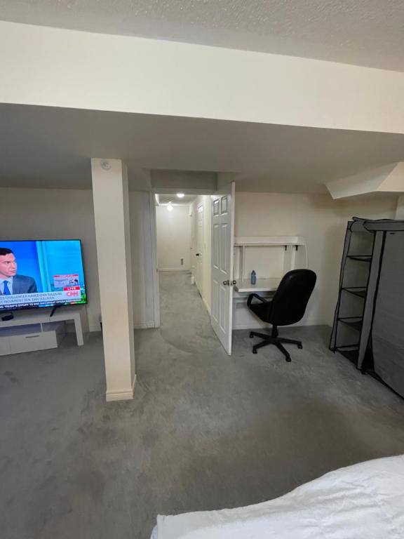 a bedroom with a bed and a desk and a chair at Comfort King in Oshawa