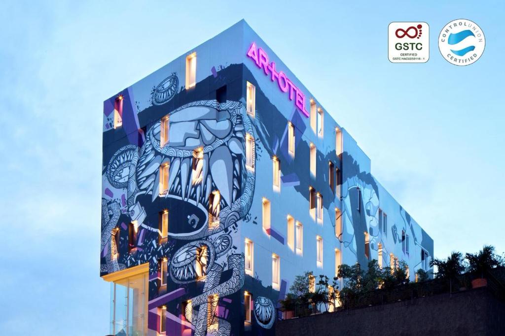 a building with a clock on the side of it at ARTOTEL Thamrin Jakarta in Jakarta