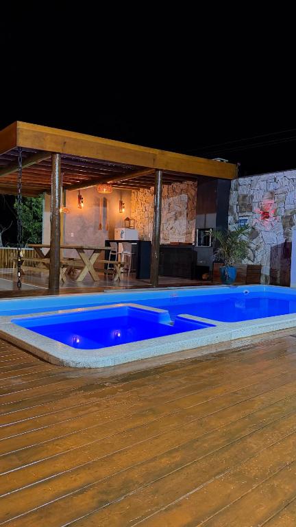 a large blue swimming pool on a wooden floor at Vista do Luar Corumbau in Prado