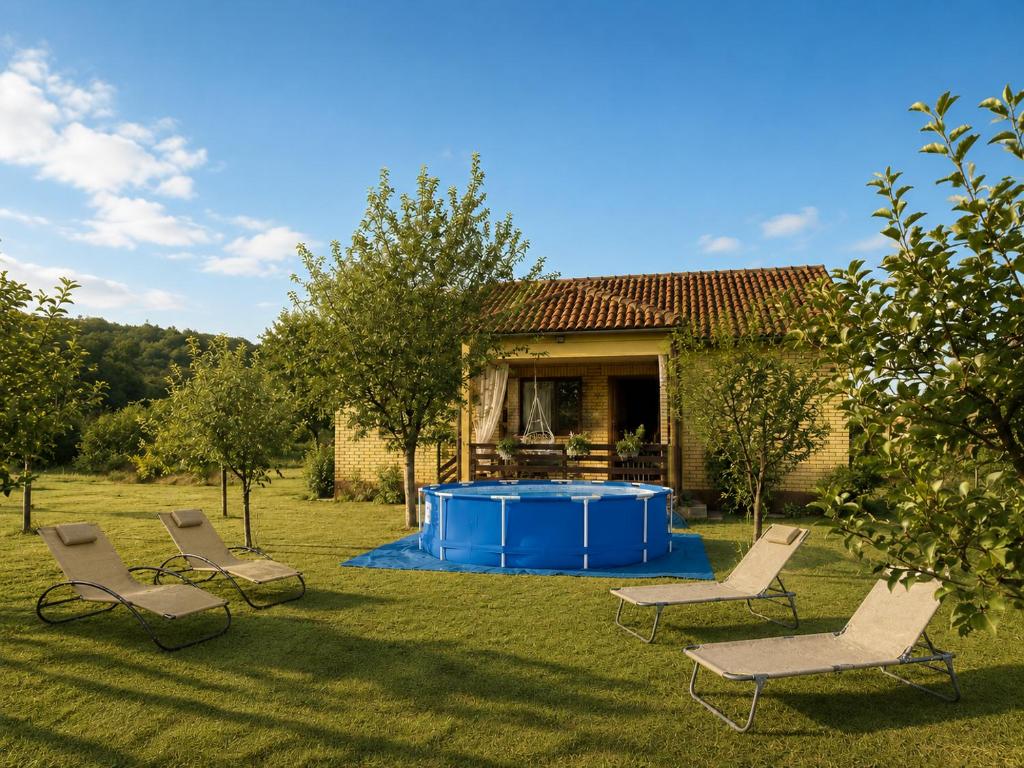 a group of chairs and a pool in a yard at Green Little Cottage with Pool near Ostrog Monastery in Danilovgrad
