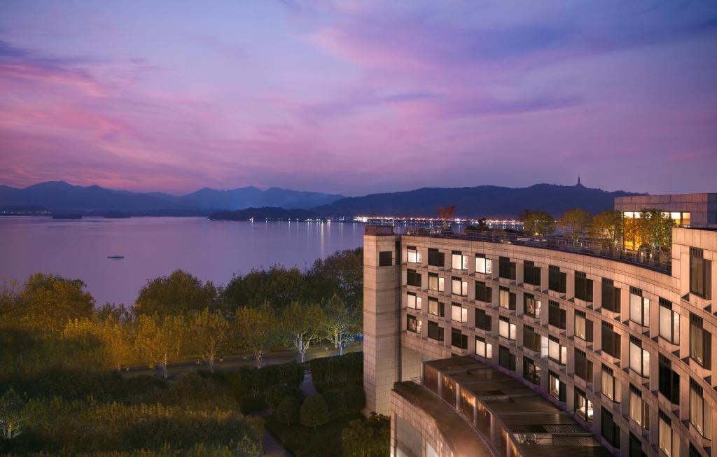 a building with a view of a body of water at Grand Hyatt Hangzhou in Hangzhou