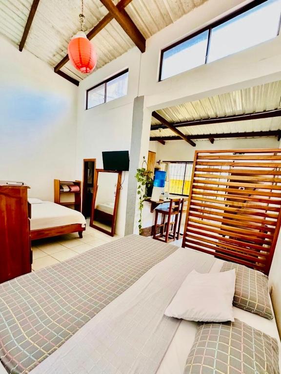 a bedroom with a large bed and a table at PROMOCIOn VILLA PRIVADA SPRING in Puerto Ayora