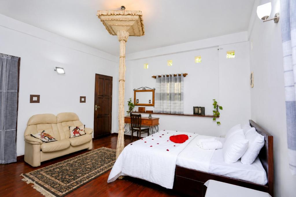 a bedroom with a bed and a table and chairs at Hilltop Retreat Matale in Matale