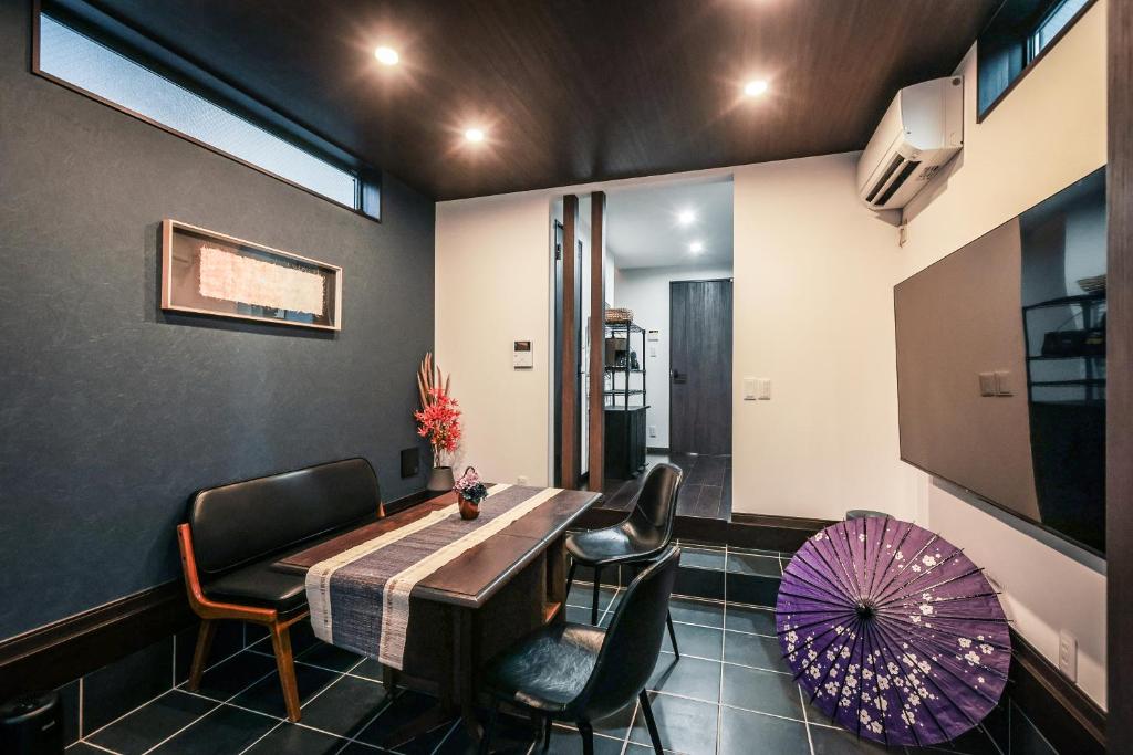 a dining room with a table and chairs and an umbrella at こだま屋 in Tokyo