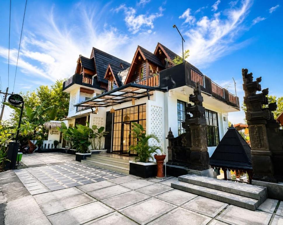 a house with a fireplace in front of it at KeJogja Homestay in Grigak