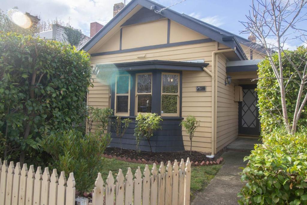 a house with a white fence in front of it at Picket Fence On Ligar in Ballarat