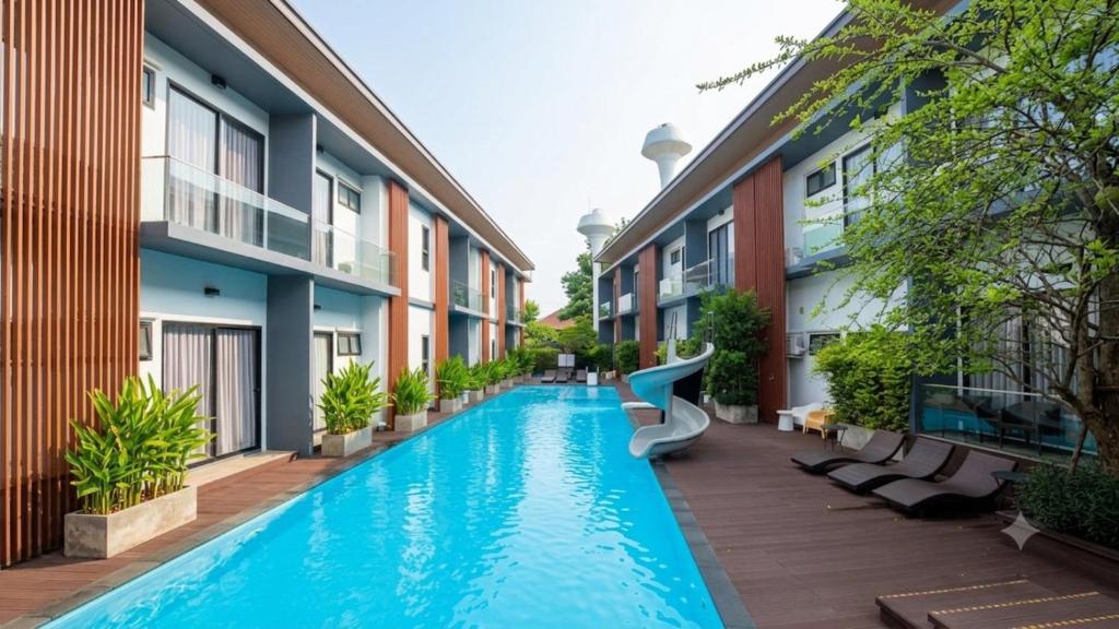 a swimming pool in the middle of a building with a slide at The RiverKwai Bridge Resort 2 in Ban Chuk Kum