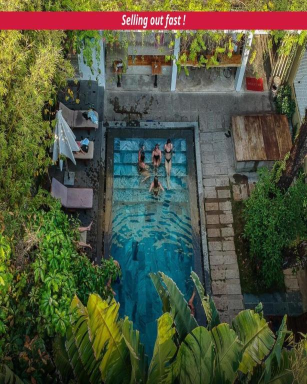 a group of people swimming in a swimming pool at 9Station Hostel & Bar Phu Quoc in Phú Quốc