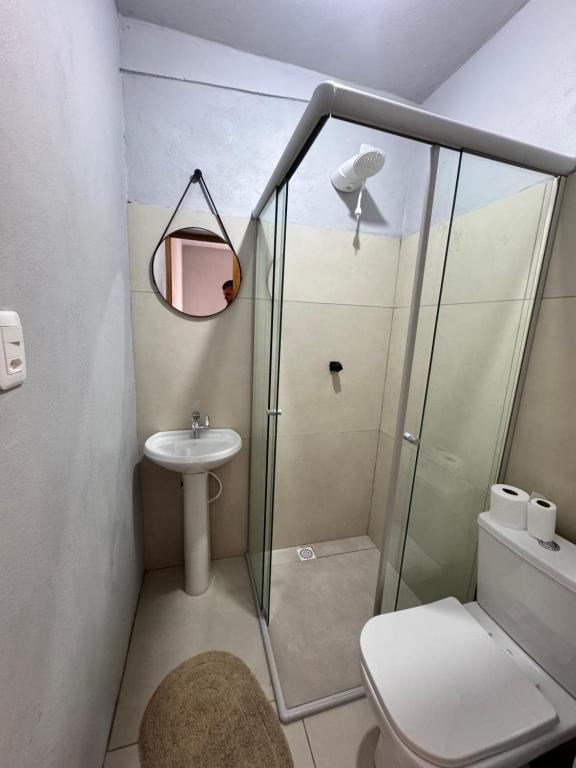a bathroom with a shower and a toilet and a sink at Pousada Bonetti Quarto 9 in Santa Rosa