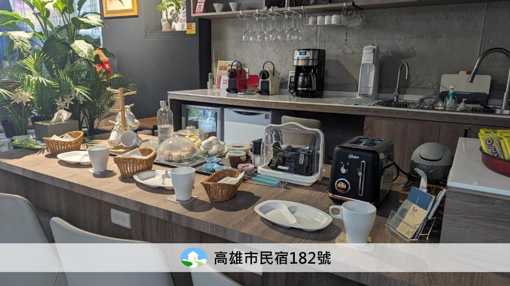 a table with dishes and a coffee maker on it at 蘆思特六合民宿 in Kaohsiung