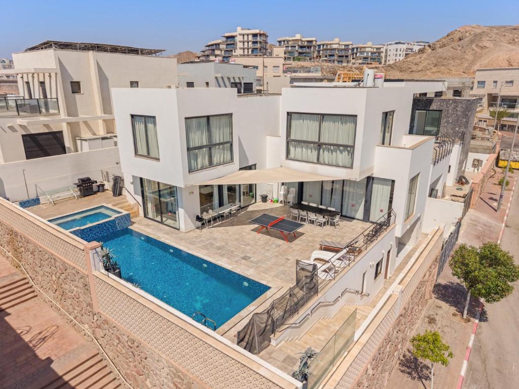 an aerial view of a house with a swimming pool at Villa Marbella Eilat in Eilat
