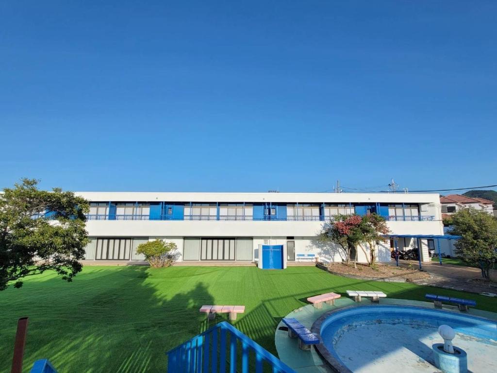 a building with a large yard and a swimming pool at 535base in Tannowa