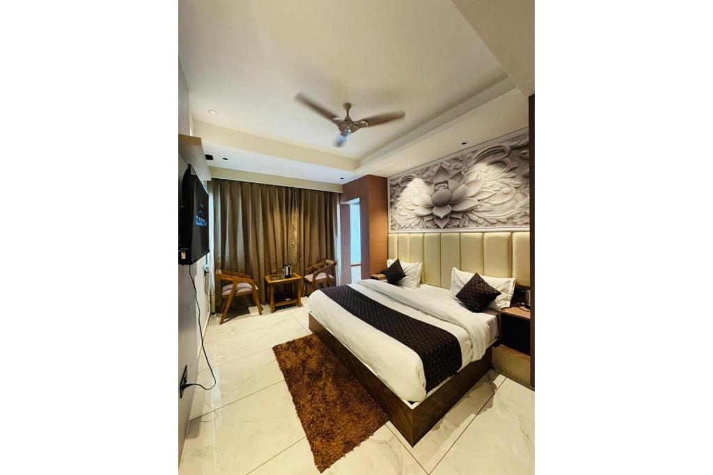 a bedroom with a bed and a ceiling fan at The Moonsoon Inn in Mussoorie