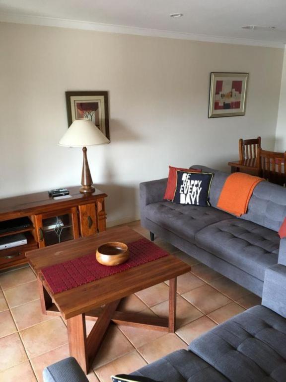 a living room with a couch and a coffee table at Seaview on Kent in Rockingham