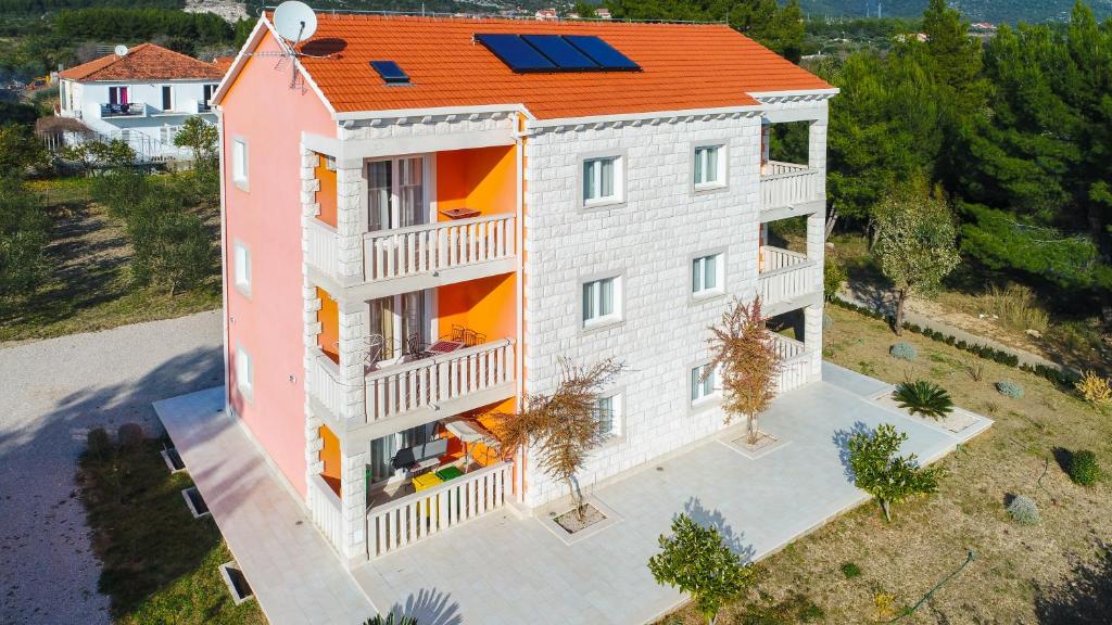 une vue aérienne sur une maison avec un toit orange dans l'établissement Apartments Viktoria, à Orebić