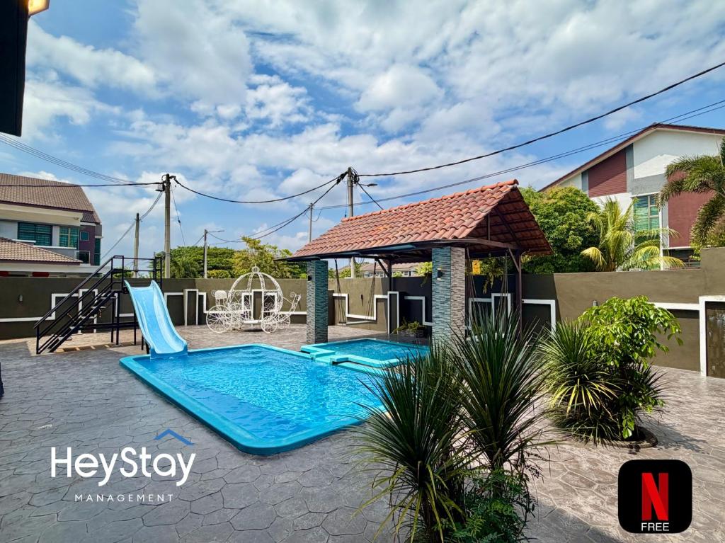 a swimming pool with a slide and a playground at Villa 20Pax4B3B PrivatePool /Karaok/Pooltable/BBQ in Malacca
