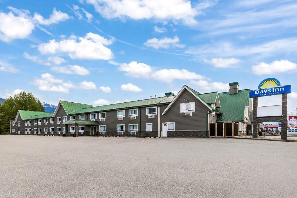 a large building with a sign in front of it at Days Inn by Wyndham Valemount in Valemount