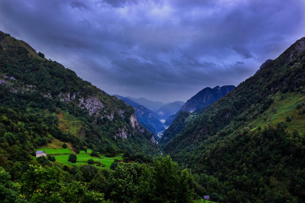 a valley in the mountains under a cloudy sky at Auberge Toison d'Or in Cette-Eygun