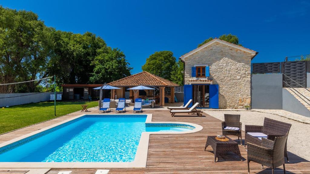 a villa with a swimming pool and a house at Lukini dvori by Villas Guide in Bibići