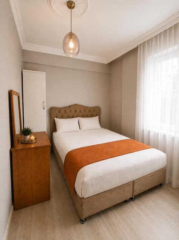 a bedroom with a large bed and a window at Kennedy Apart Hotel Kumkapı Istanbul in Istanbul