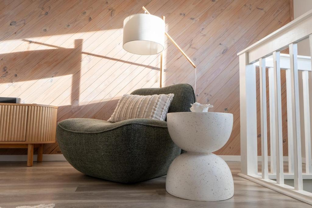 a living room with a chair and a lamp at The Rye Reset in Rye