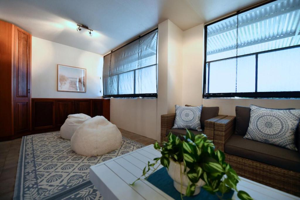 a living room with a couch and a large window at Barefoot Bliss in Rockingham