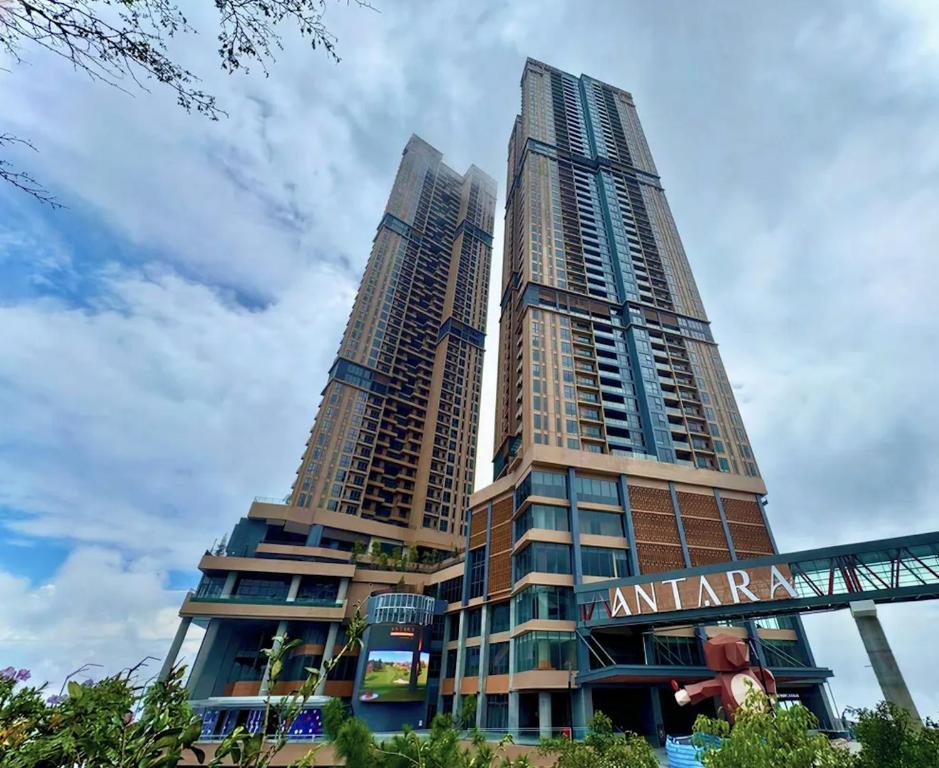 two tall skyscrapers with a sign in front of them at Antara Residence By KLIQ in Genting Highlands